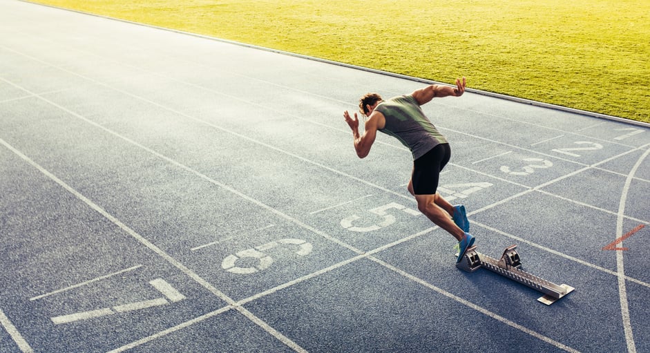 Sprinter Taking off from Starting Block on Running Track